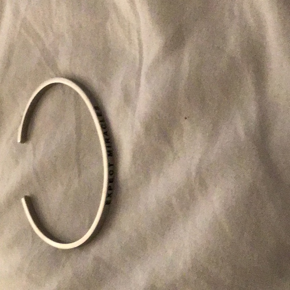 Silver bracelet that says expect miracles